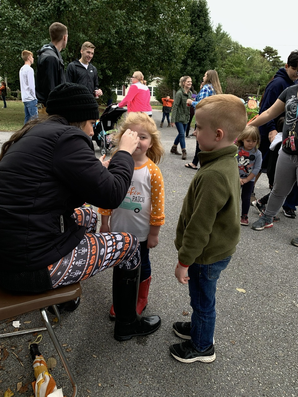 A volunteer paints a child’s face at Lindsey’s Fall Festival